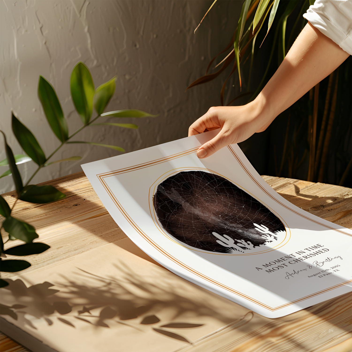 An outstretched hand laying down a personalized SentiMap print onto a wooden desk