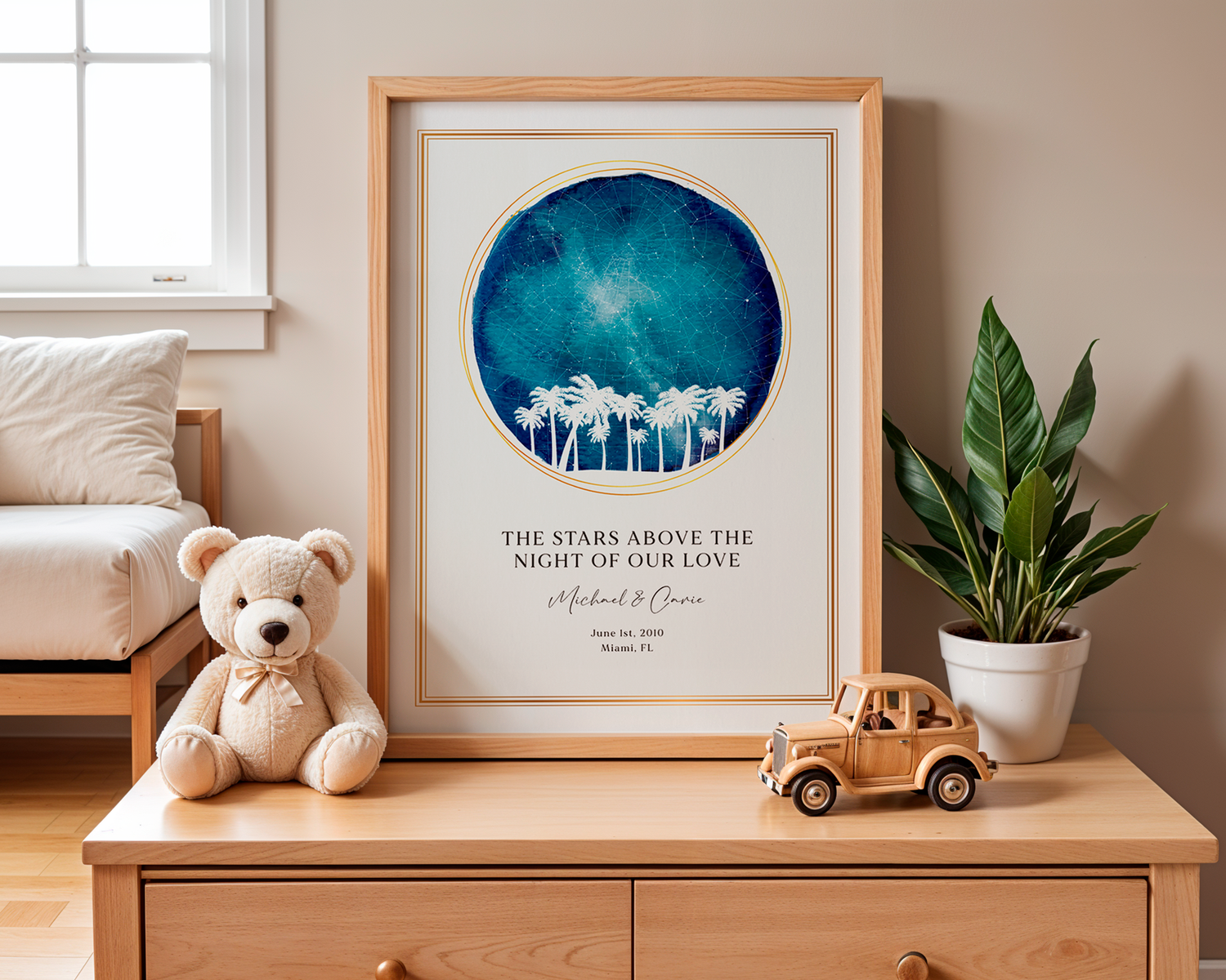 A framed SentiMap customized meaningful moment print of someones wedding night leaning against a wall on a wooden desk with a cute teddy bear, a toy car and a small plant surrounding the print in someones living room