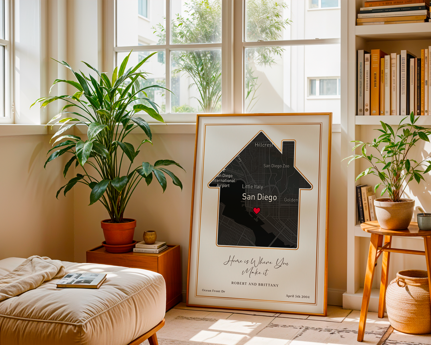 Framed customized home SentiMap print of someones home in San Diego, California leaning against a wall in someones home surrounded by plants and furniture and a book shelf