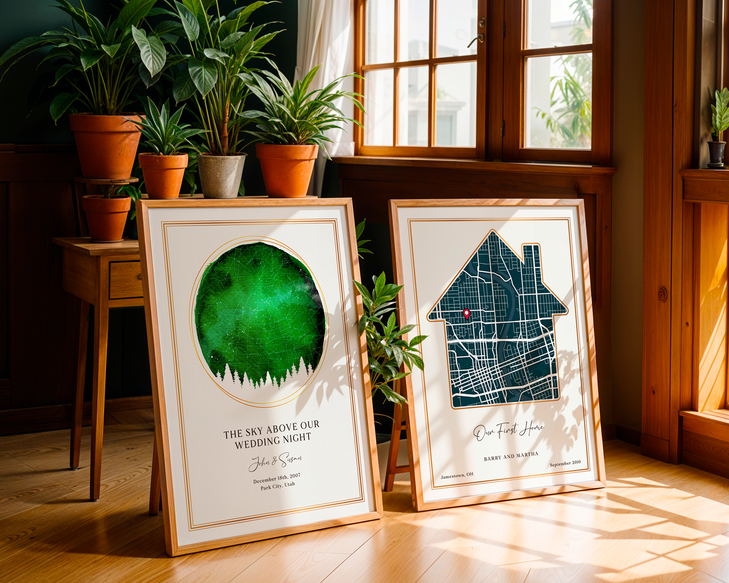 Two SentiMap customized prints leaning against a table on the floor surrounded by plants in pots and a wooden cabin surrounding