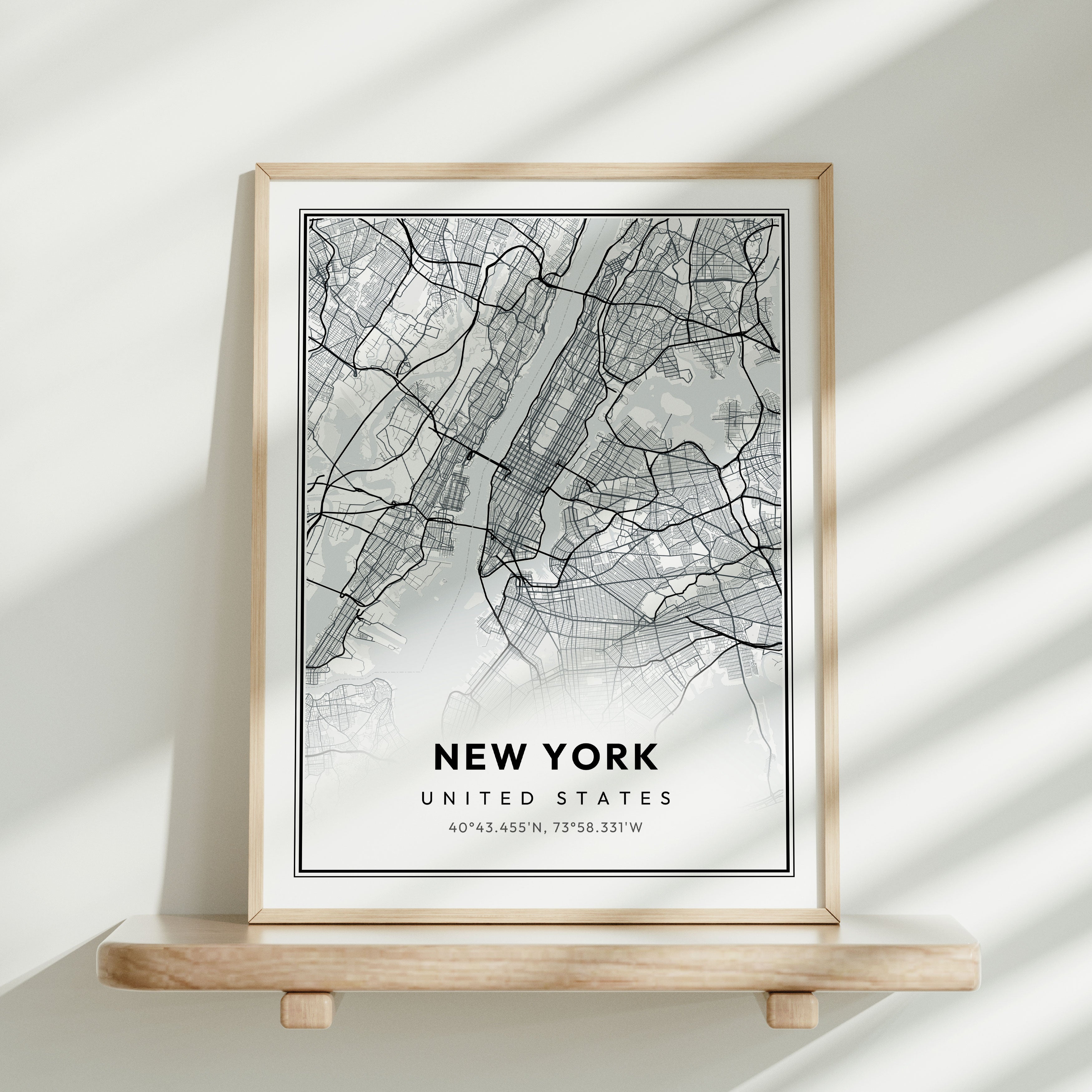 Framed Modern Street Map leaning against a wall on a shelf