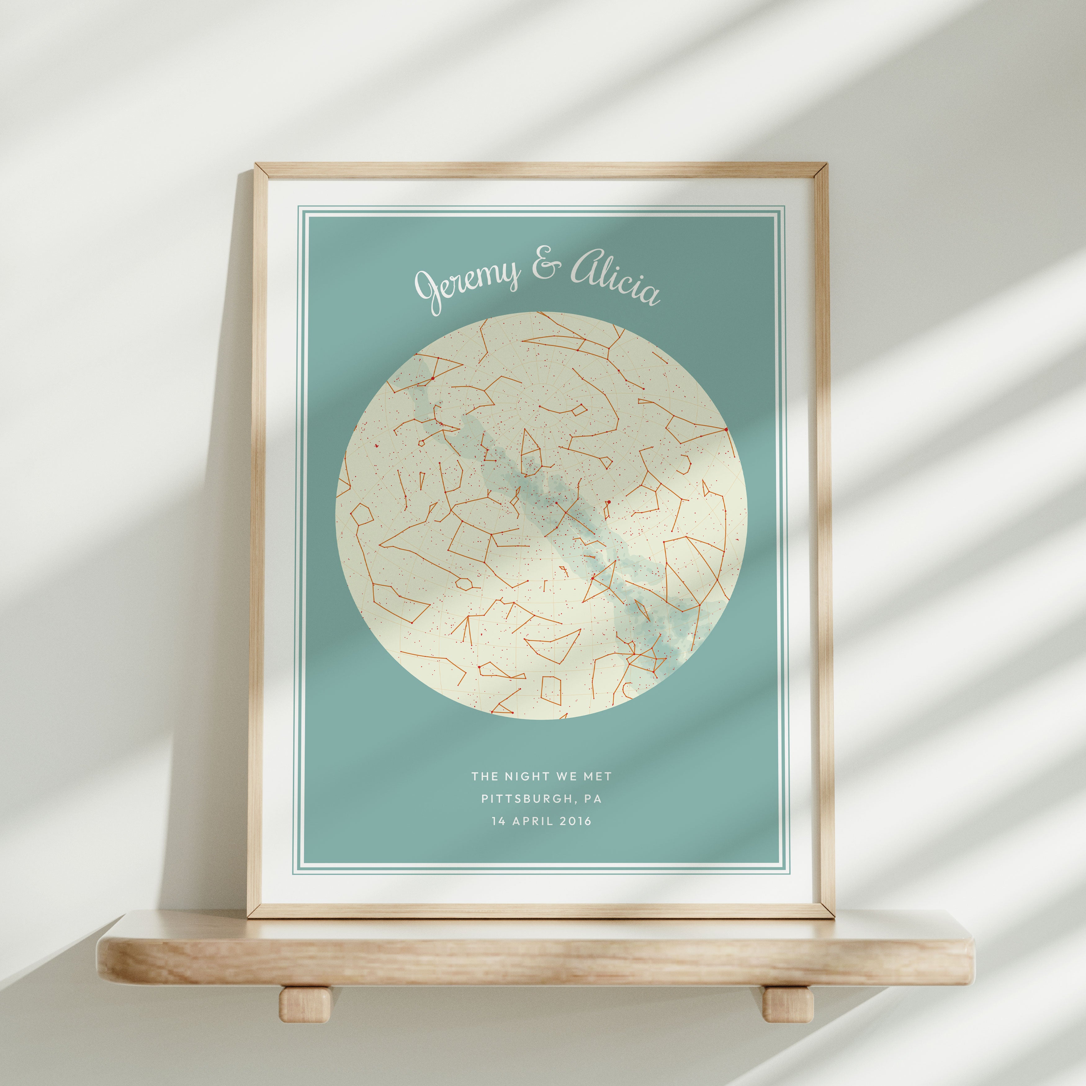Framed Modern Star Map leaning against a wall on a shelf