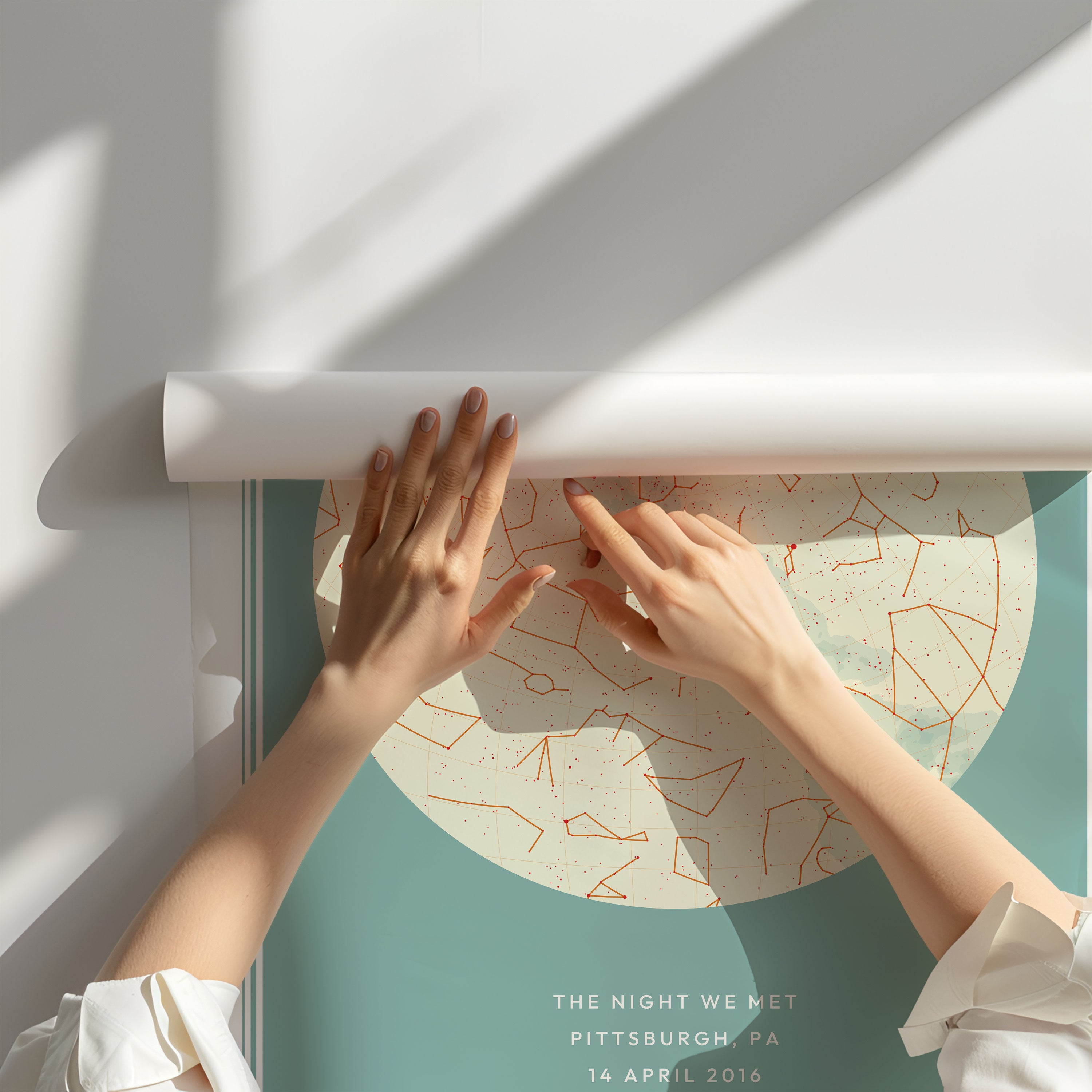 Modern Street Map print with a hand holding it against a green bush with white roses around